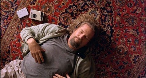 A man laying on the ground with headphones