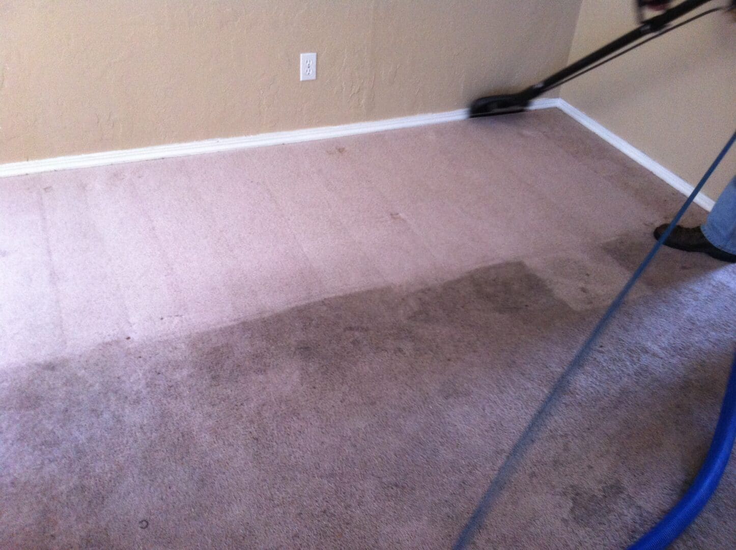 A carpet cleaning machine is being used to clean the floor.